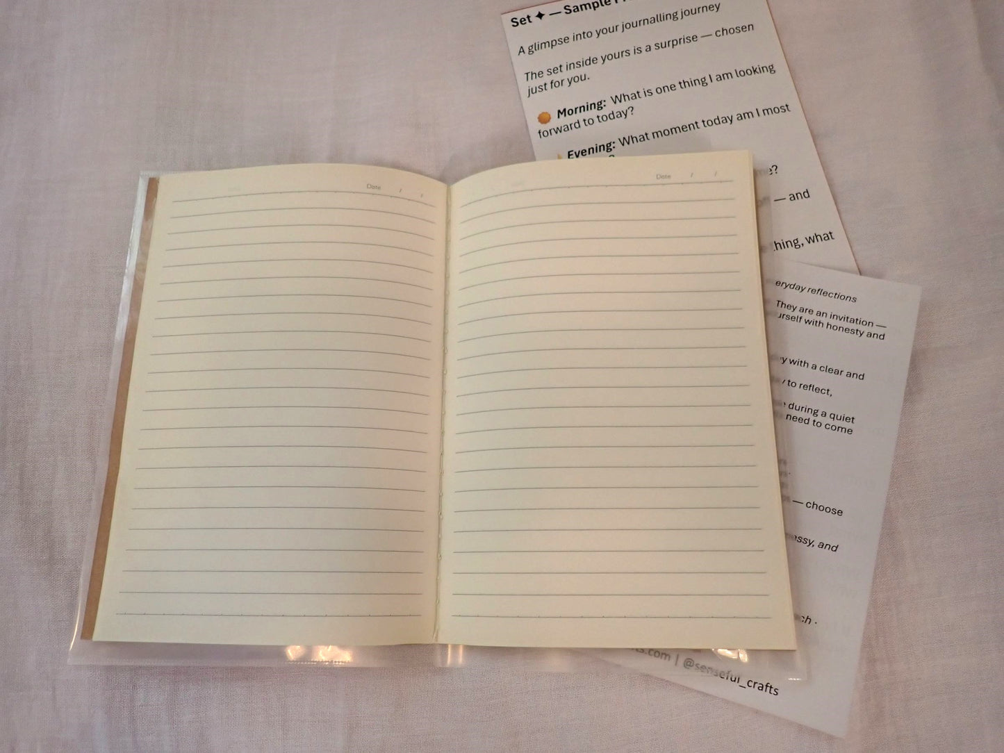 Mindful Journal open showing cream lined pages with prompt inserts alongside