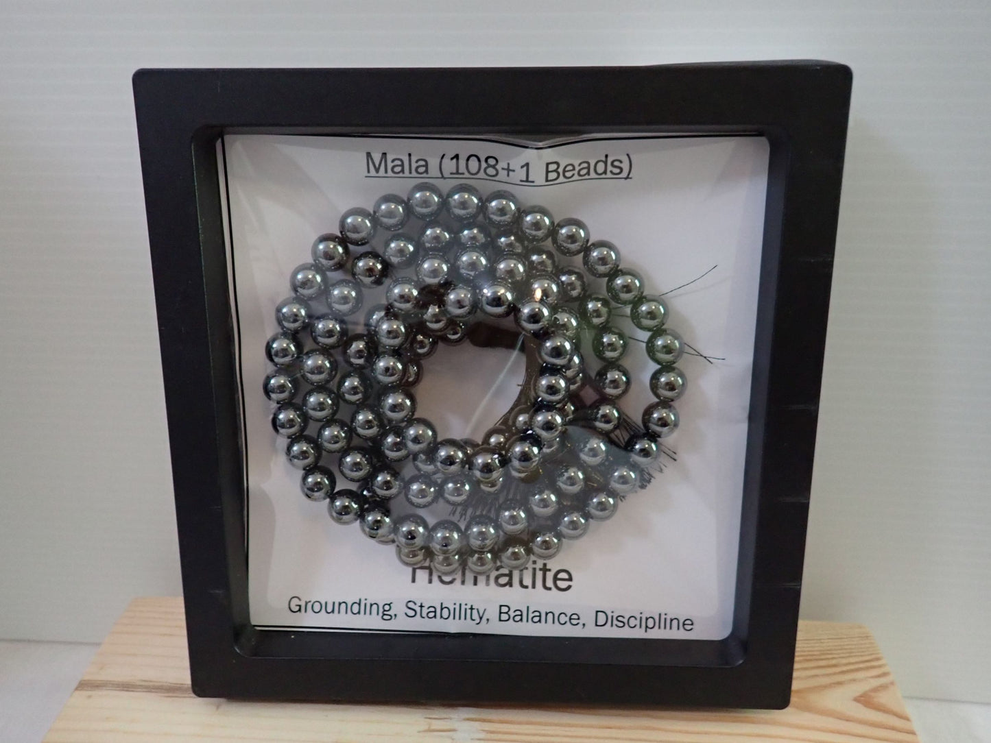 Hematite Mala displayed in shadow box frame - Grounding Stability Balance Discipline