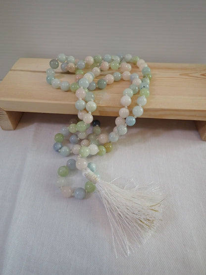 Morganite Mala 108+1 beads with white tassel on wooden stand