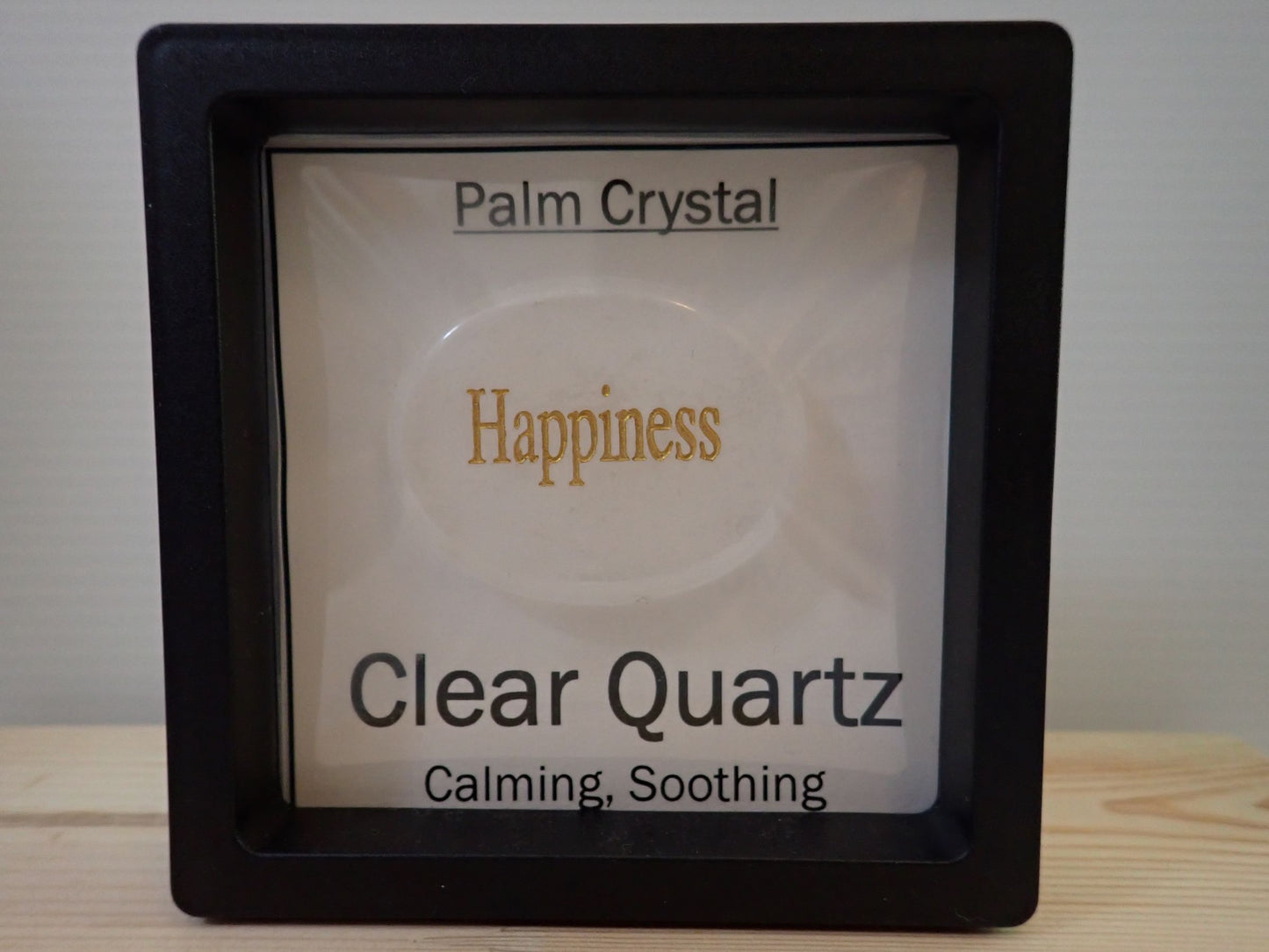 Clear Quartz Palm Stone in floating display frame - Happiness