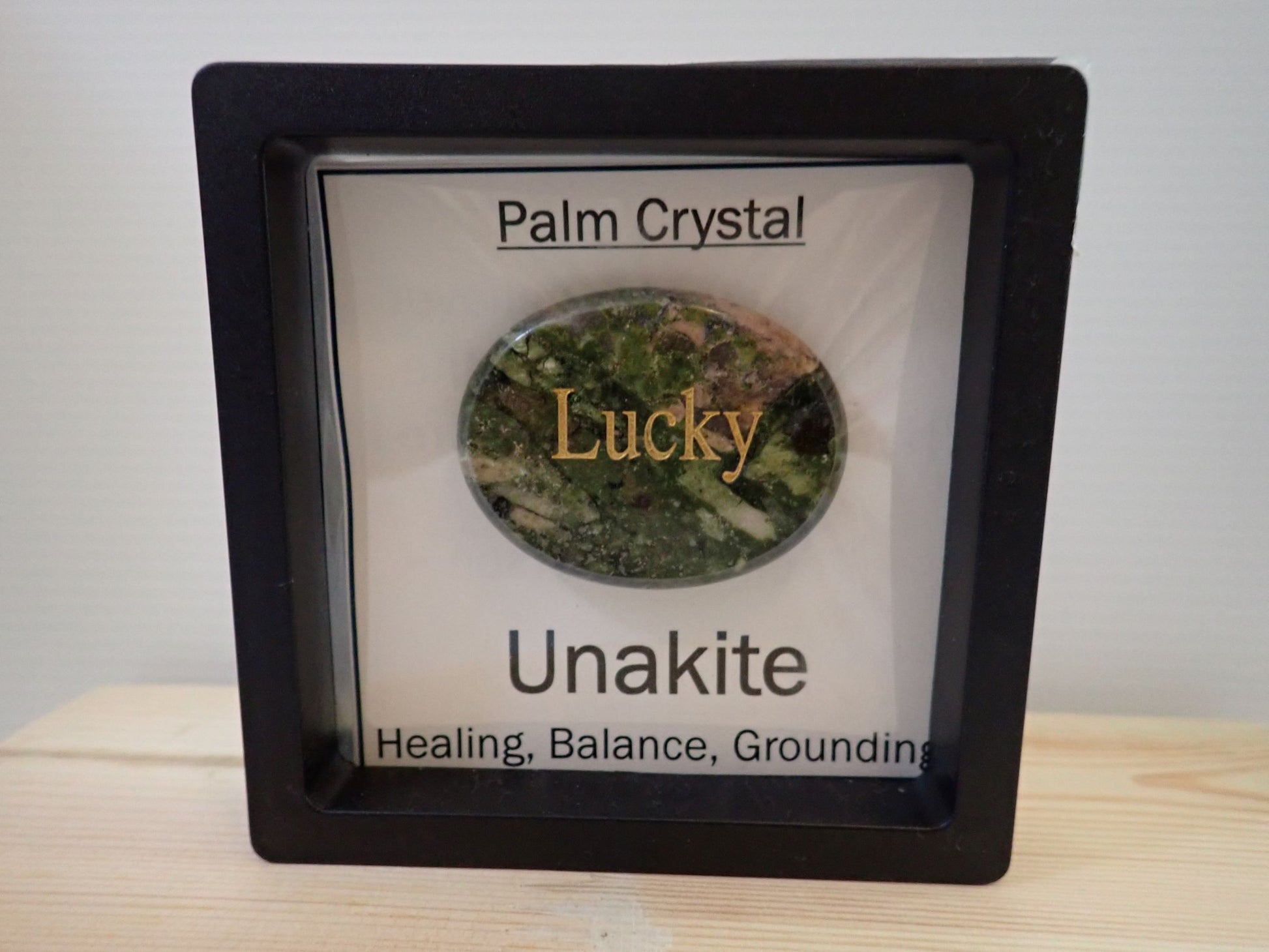 Unakite Palm Stone in floating display frame - Lucky