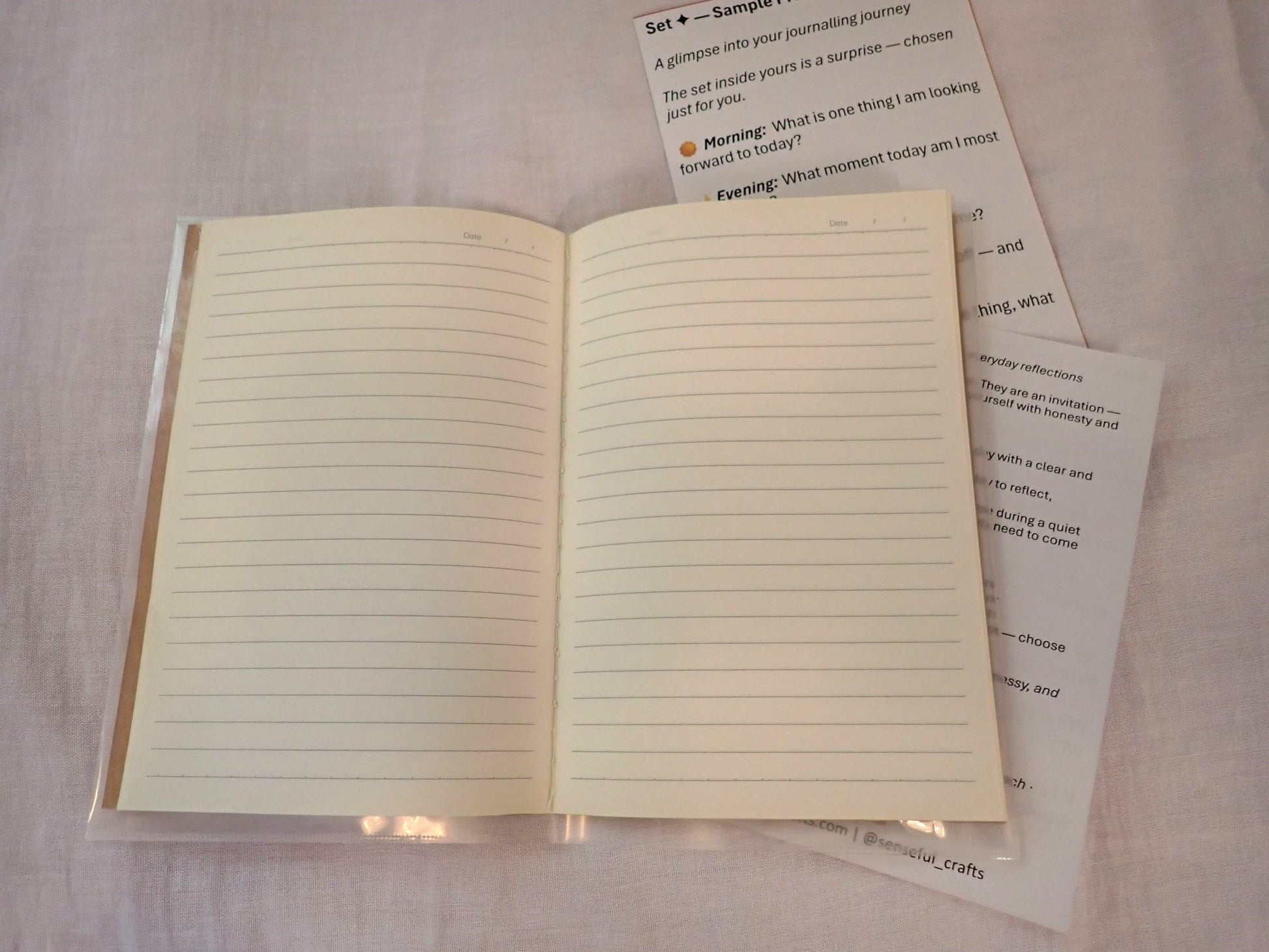 Mindful Journal open showing cream lined pages with prompt inserts alongside