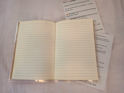Mindful Journal open showing cream lined pages with prompt inserts alongside